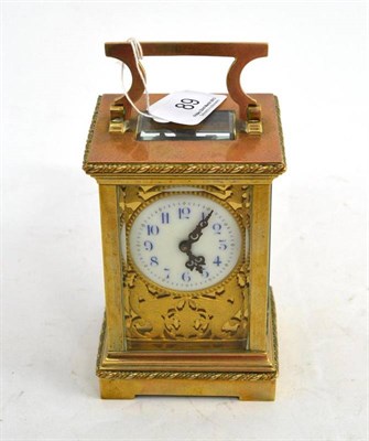 Lot 89 - Brass carriage clock with enamel dial and chased decoration, with key