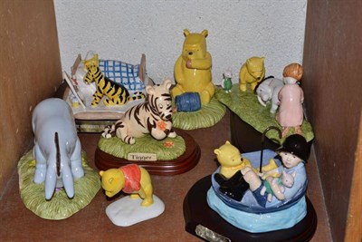Lot 101 - Royal Doulton Winnie the Pooh figures including Winnie the Pooh in an armchair, Eeyore nose to...