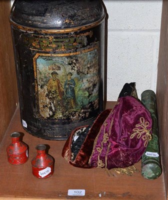 Lot 102 - A Toleware tea canister, three other tin canisters and three velvet smoking hats