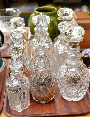 Lot 143 - A tray of assorted glass decanters, some with silver decanter labels