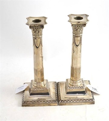 Lot 196 - A pair of loaded silver candlesticks