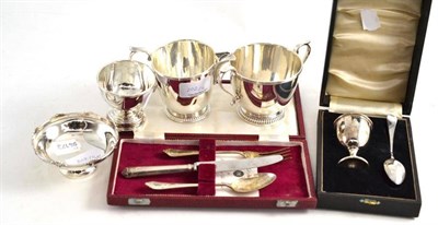 Lot 202 - A christening knife, a cased fork and spoon, a cased egg cup and spoon, a milk jug and sugar...