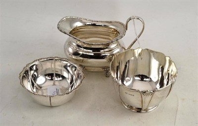 Lot 208 - A silver milk jug, a silver sugar bowl and a silver dish (3)