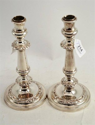 Lot 214 - A pair of electroplate candlesticks