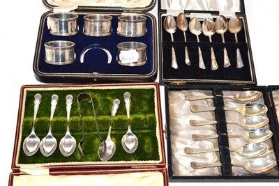 Lot 217 - Five silver napkin rings, two sets of six teaspoons and a set of teaspoons and tongs (one missing)