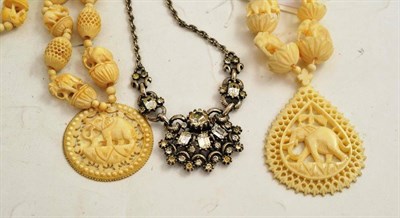 Lot 237 - An elephant motif carved ivory necklace, another and a paste costume jewellery necklace