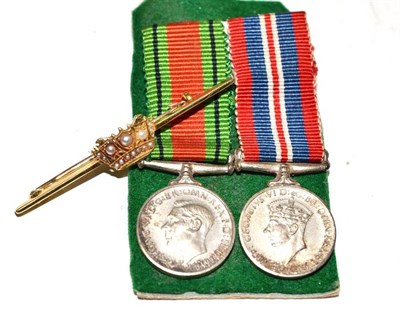 Lot 255 - A 15ct gold and pearl military brooch and a pair of miniature medals