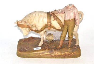 Lot 283 - A Royal Dux cow and boy group (a.f.)