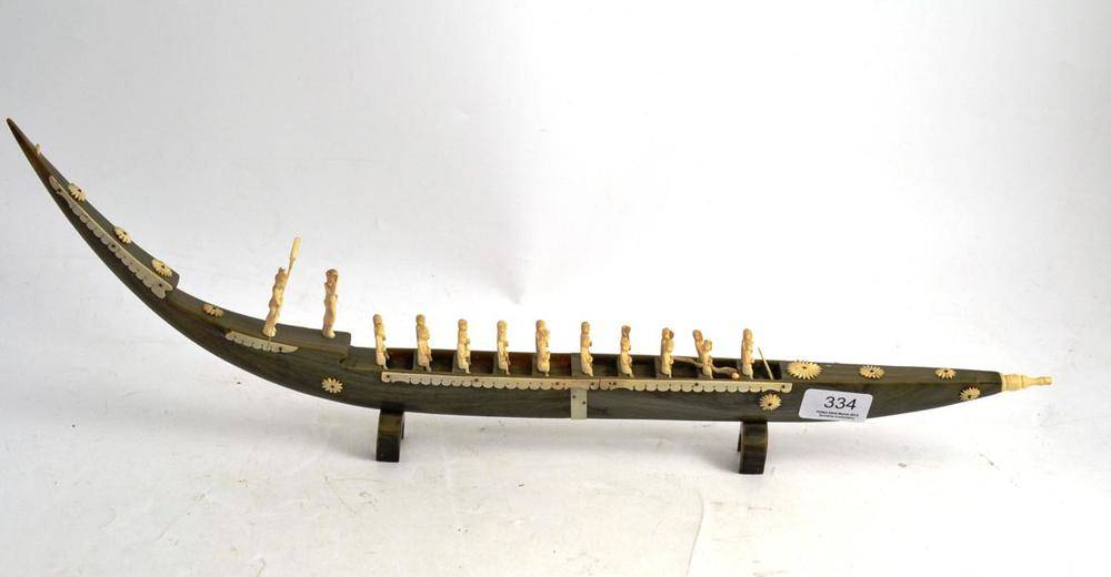 Lot 334 - An Indian marriage dowe, the boat carved from a horn with figures carved from ivory