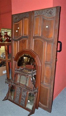 Lot 729 - A pair of carved walnut wardrobe doors, a modern hall mirror and an overmantel mirror