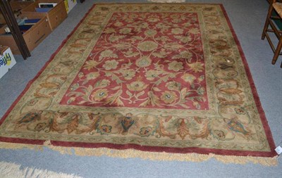 Lot 754 - Red ground patterned wool carpet