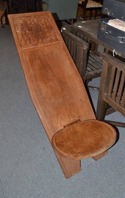 Lot 787 - A Nigerian hardwood Chair, of light golden colour, made up of two interlocking panels, the tall...