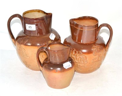Lot 45 - Three Doulton stoneware water jugs sprigged with hunting and drinking scenes