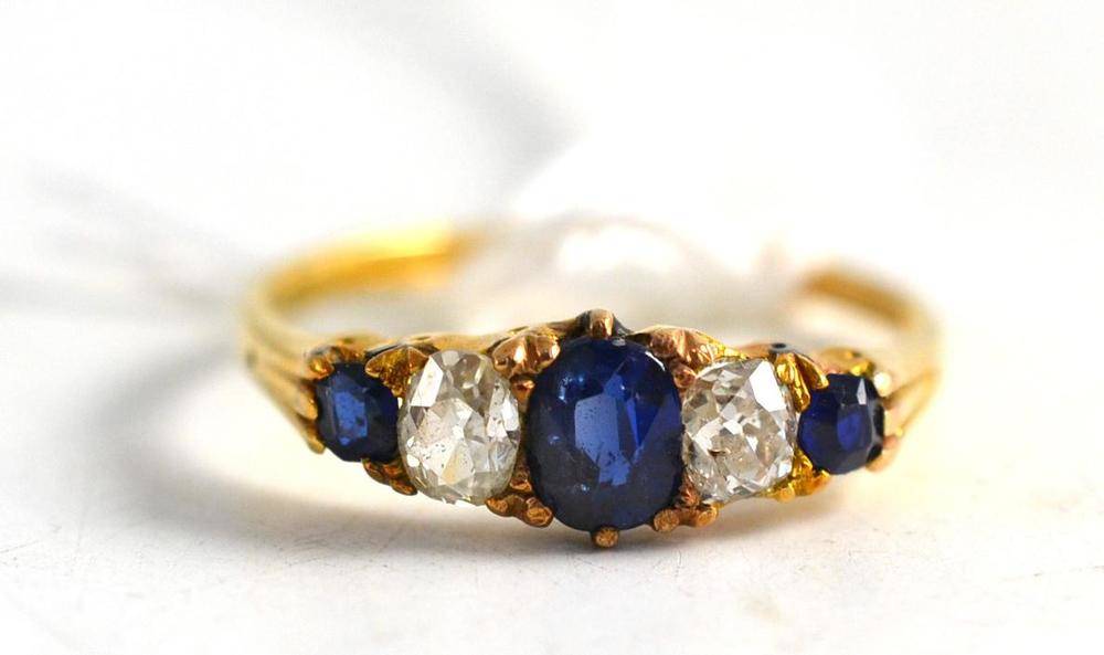 Lot 97 - An 18ct gold diamond and sapphire five stone ring