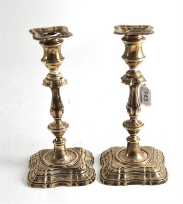 Lot 143 - A pair of loaded silver candlesticks