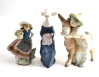 Lot 176 - Lladro group of a boy and donkey, a Lladro figure of a nun and a Lladro flower girl