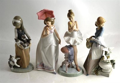 Lot 188 - Four Lladro figures comprising a ballerina, a girl with cat, a girl with doves and a girl with...