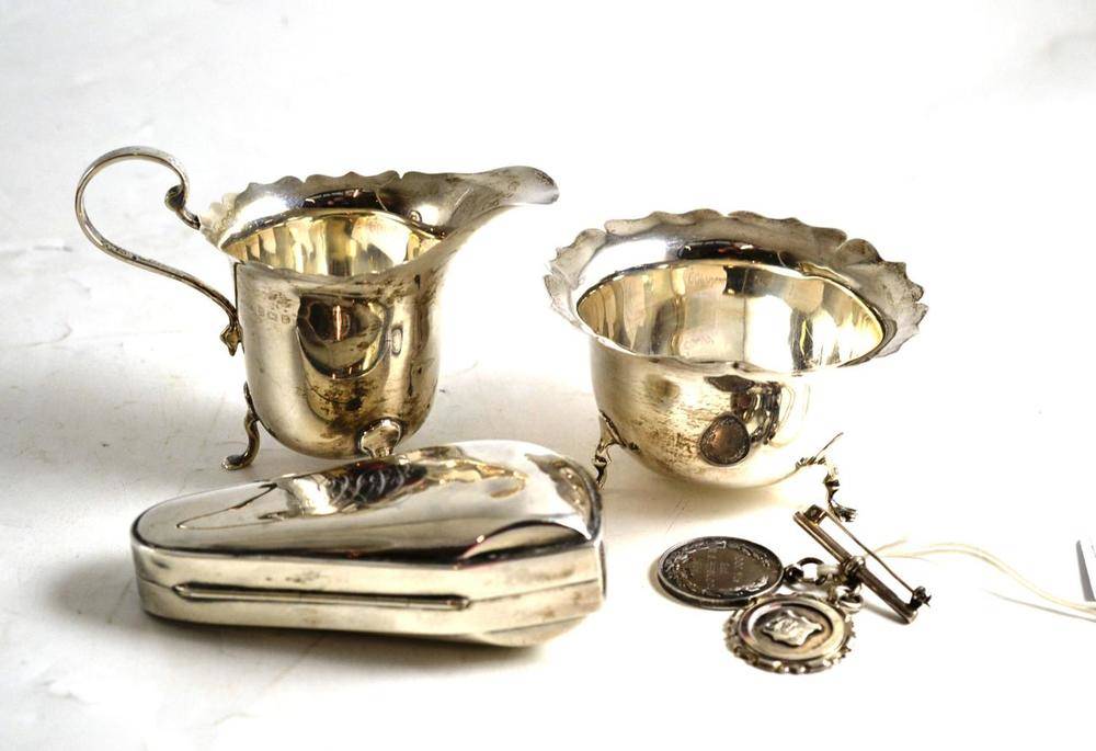 Lot 213 - Silver milk jug and sugar bowl, silver pipe case, silver medal and a silver fob
