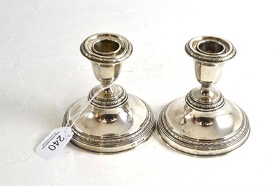 Lot 240 - Pair of loaded silver dwarf candlesticks
