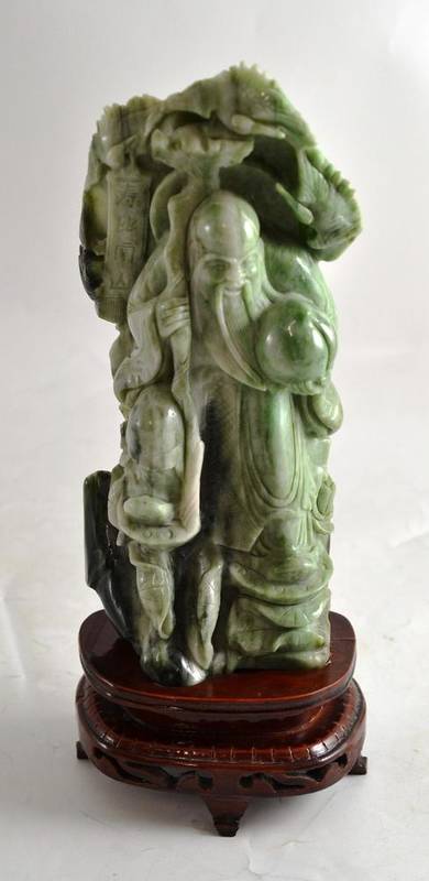 Lot 241 - A Chinese green hardstone Shou Lao and stand