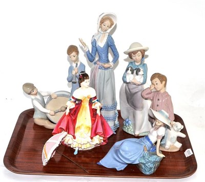 Lot 277 - A Lladro figure of a woman, Lladro group of two boys, two Nao figures and a Doulton figure