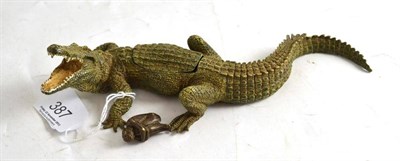 Lot 387 - A cold painted bronze of a crocodile, it's back with a lift-off panel concealing a nude woman,...