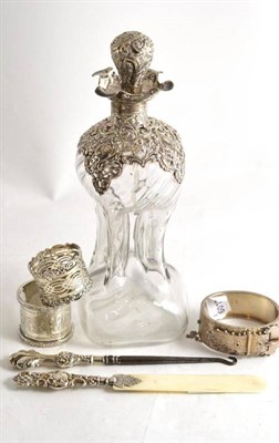 Lot 388 - A silver mounted decanter and stopper, two napkin rings, bracelet, button hook and paper knife