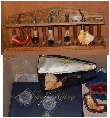 Lot 396 - An oak pipe rack, with six pipes and cased cheroot holder, together with coins