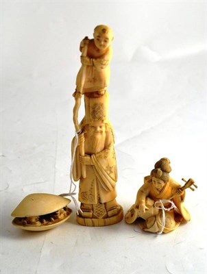 Lot 429 - Carved ivory figure group of a sage with young boy on his shoulders, carved figure of seated...