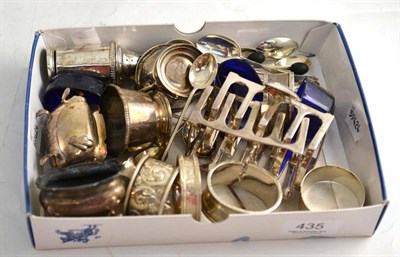 Lot 435 - A pair of silver toast racks, six napkin rings, composite cruet set and coffee bean spoons