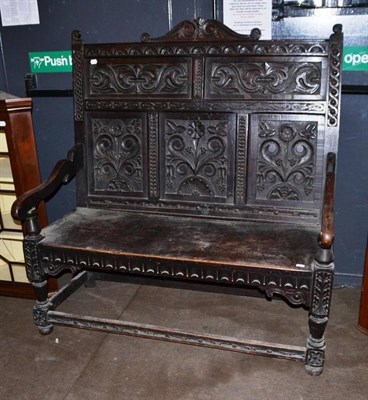 Lot 524 - Carved oak high back settle