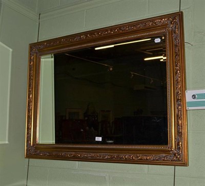 Lot 527 - A modern gilt framed rectangular wall mirror