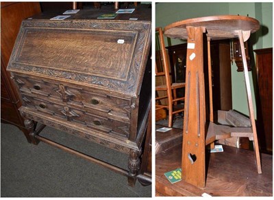 Lot 544 - Arts & Crafts oak table and a carved oak bureau