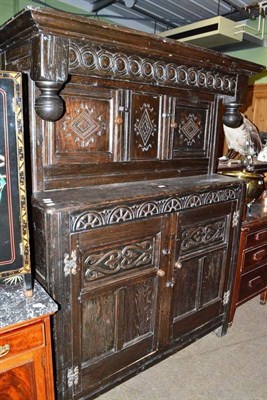 Lot 552 - A late 18th century carved oak court cupboard