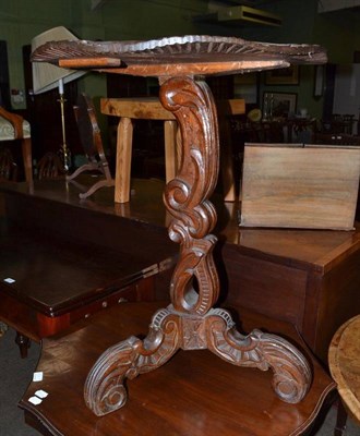 Lot 560 - A 19th century carved oak tripod table