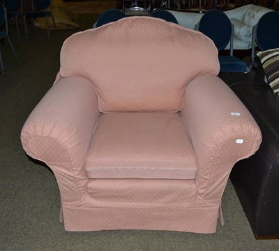 Lot 582 - A large upholstered armchair with loose covers