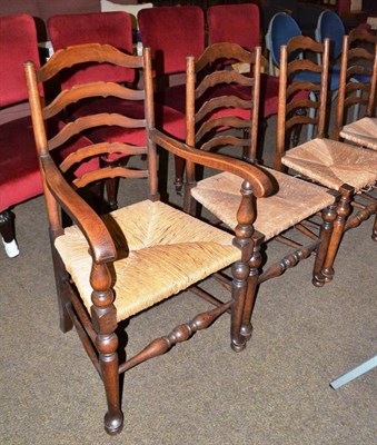 Lot 589 - A beech framed ladder back armchair with rush seat and four similar dining chairs