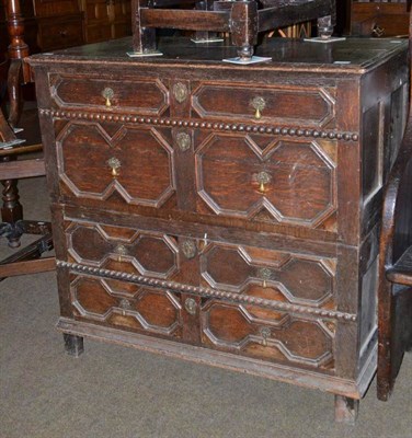 Lot 595 - An 18th century geometric carved oak three height chest of drawers