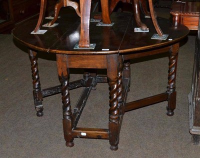 Lot 597 - An 18th/19th century oak barley twist gateleg table