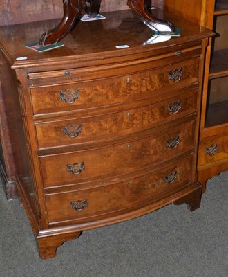 Lot 604 - A reproduction walnut bow front dressing chest