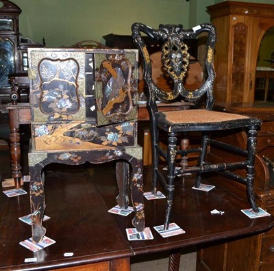 Lot 609 - Black lacquered bedroom chair inlaid with mother-of-pearl and table cabinet on stand (2)