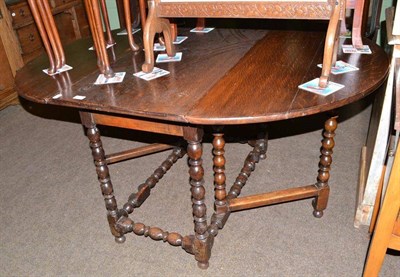 Lot 615 - An early 18th century oak gateleg table