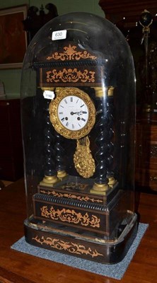 Lot 630 - An ebonised and inlaid gilt metal mounted Empire style clock under glass dome