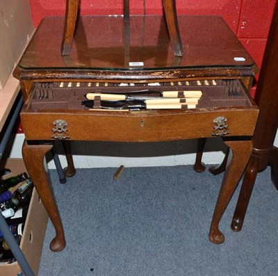 Lot 652 - An oak canteen table of Elkington & Co plated cutlery