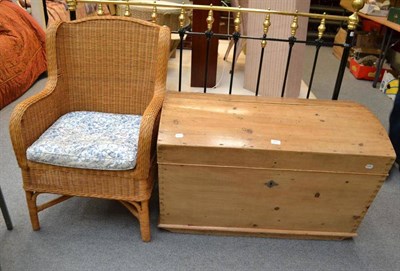 Lot 671 - A pine domed blanket chest and a wicker armchair