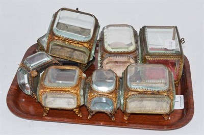 Lot 1 - Eight various Palais Royale style gilt metal caskets with bevelled glass panels