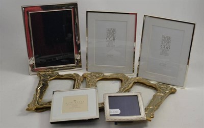 Lot 10 - A silver photograph frame, another, three brass Art Nouveau photograph frames and three white metal