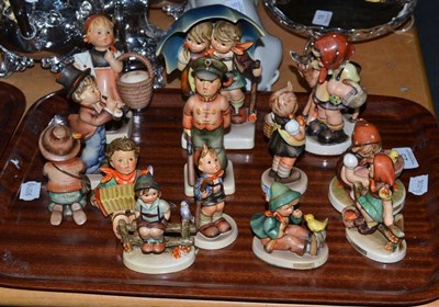 Lot 25 - A large Hummel figure of a boy and girl under an umbrella, twelve various Hummel and Goebel figures