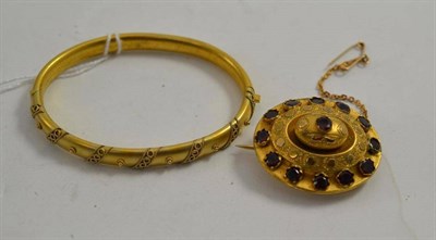 Lot 63 - A Victorian garnet set brooch and a Victorian bangle