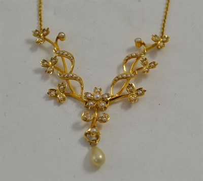 Lot 64 - An Edwardian seed pearl set floral motif necklace, stamped '15c'